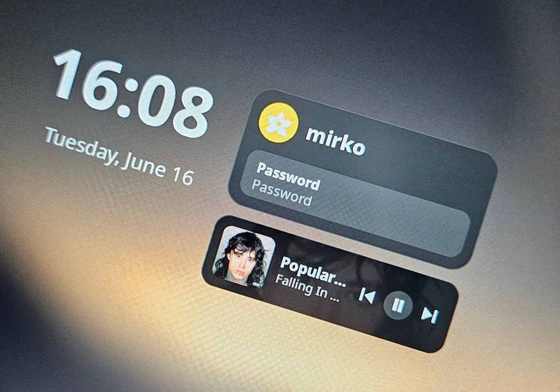 The lock screen with the now-playing card and its controls